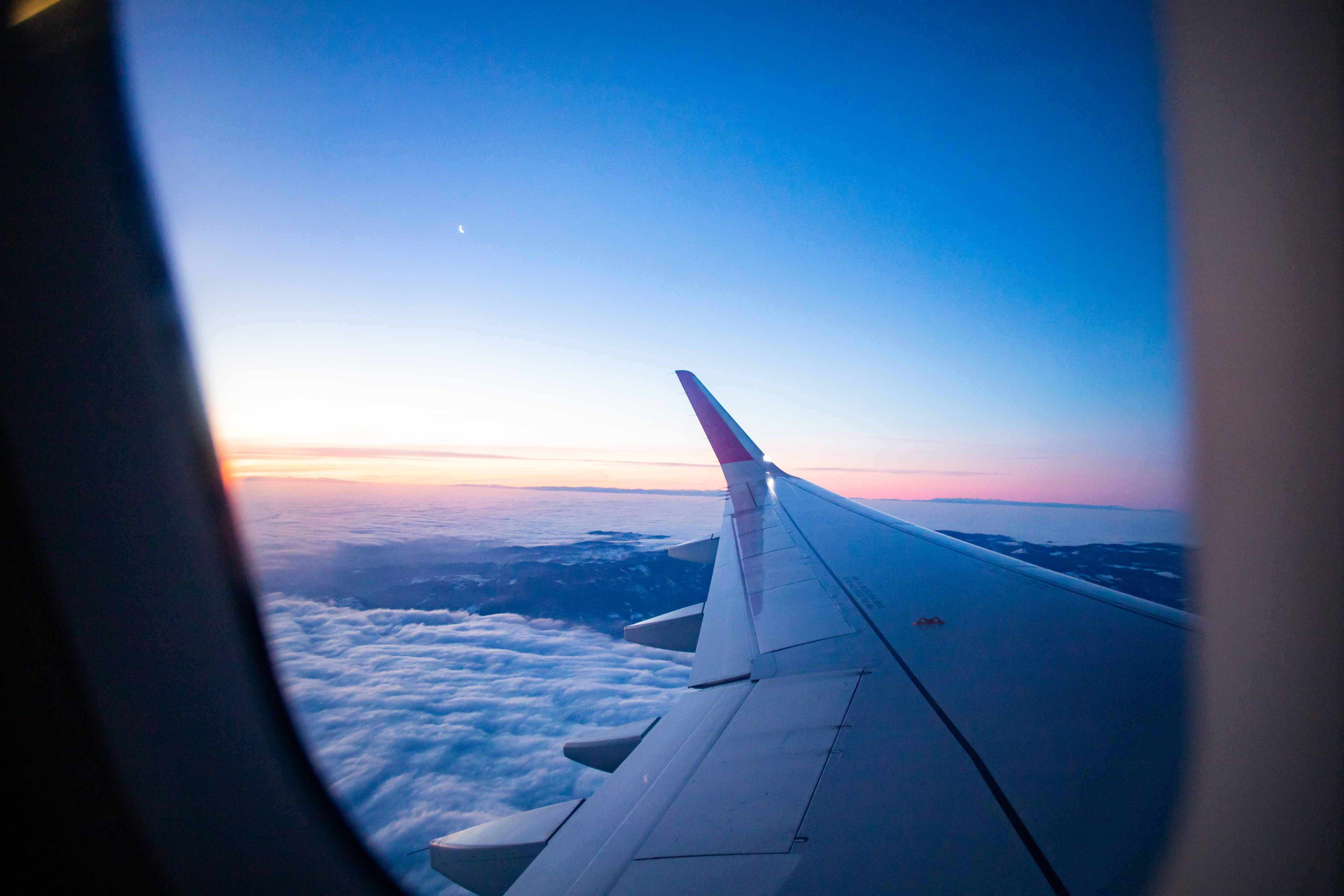 Airplane wing over clouds